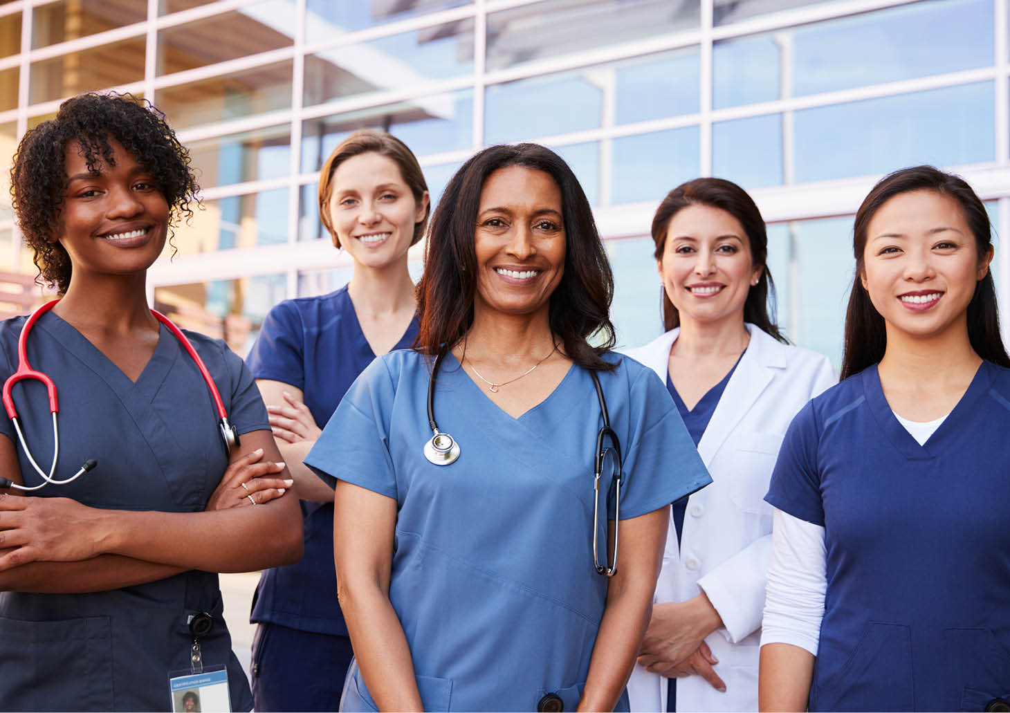 Female healthcare colleagues standing outside hospital