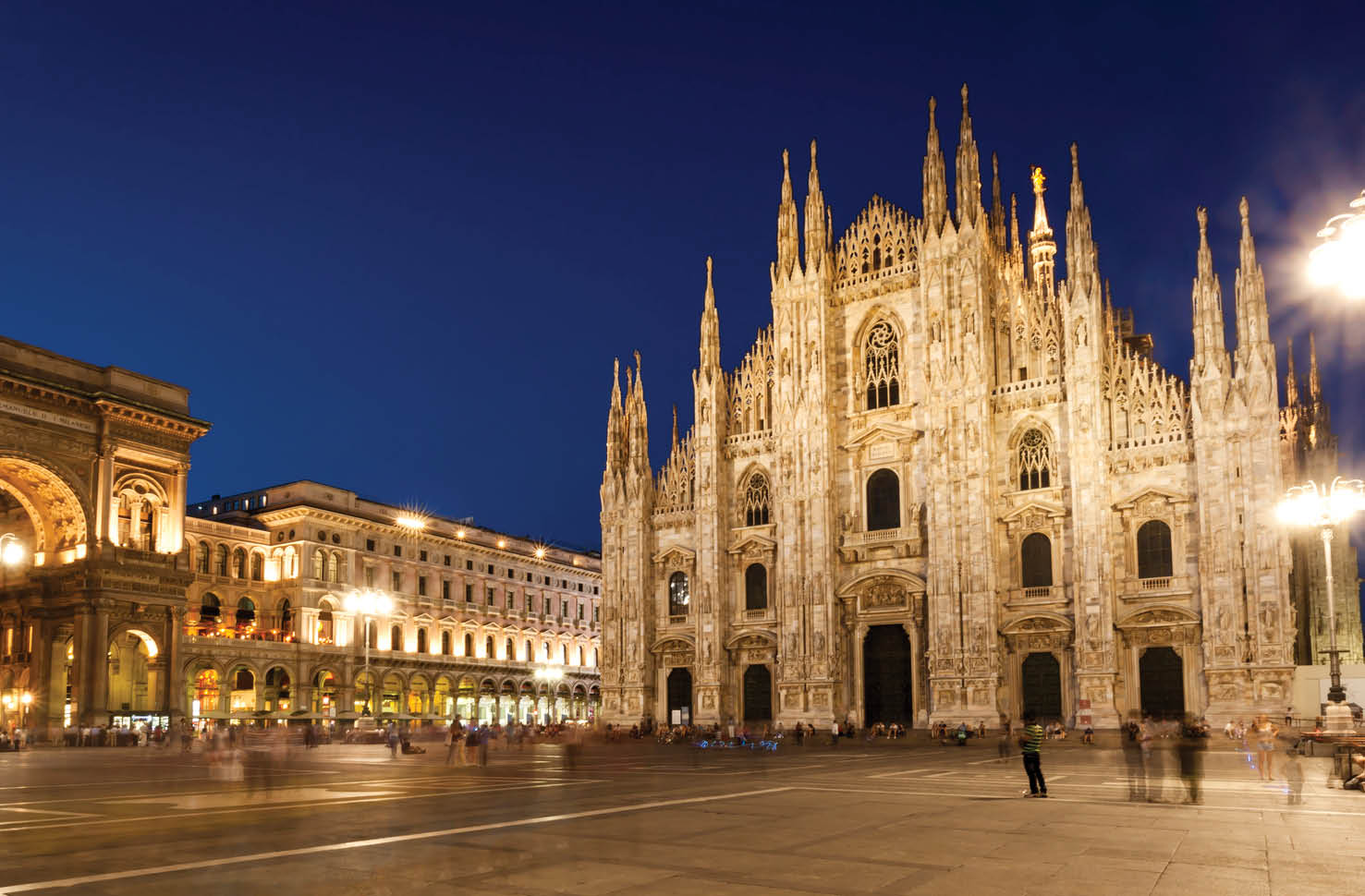 Milan Cathedral at night, panorama including Vittorio Emmanuele II gallery.